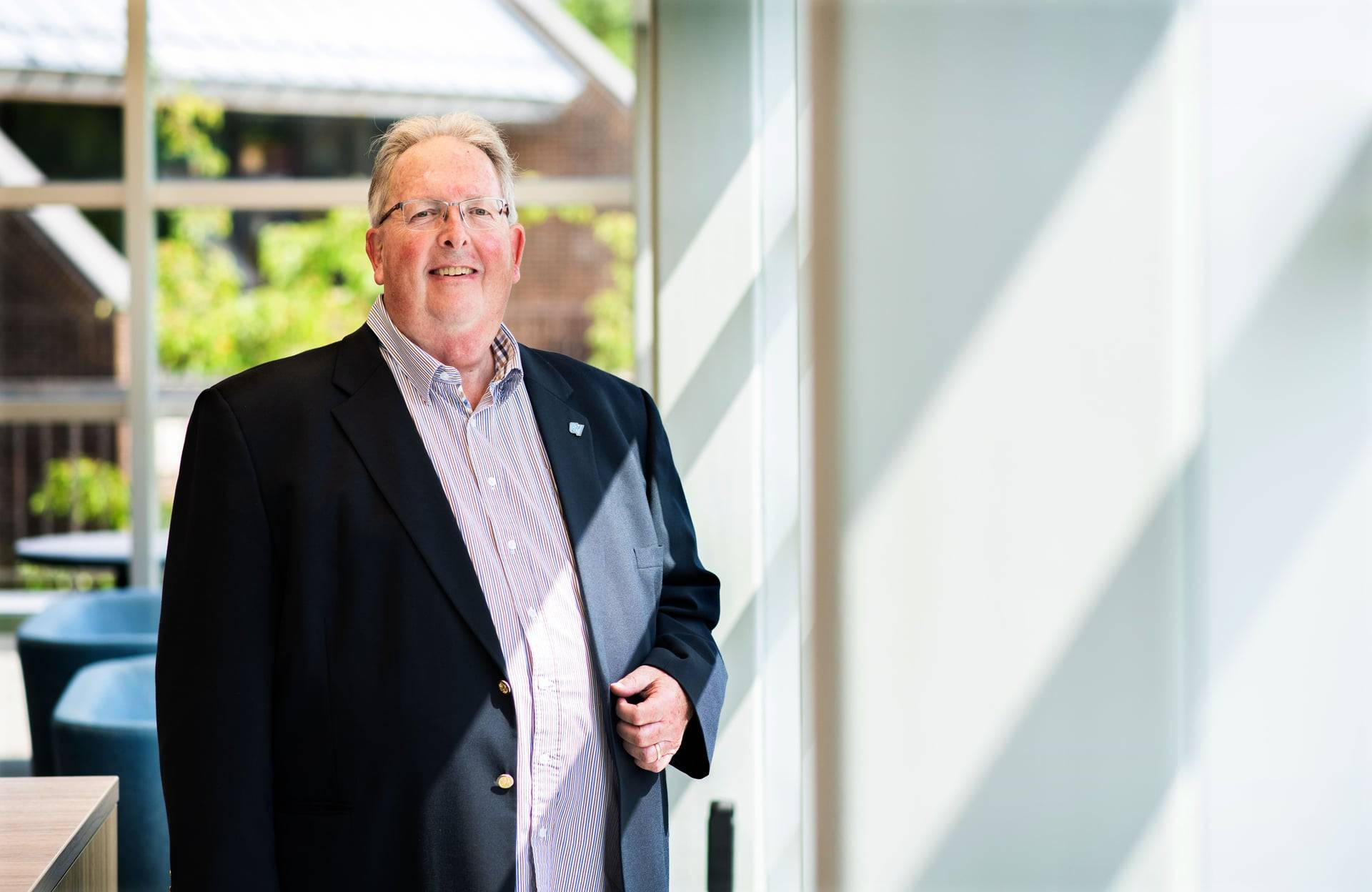 Bob Stoll stands in Kirkhof next to a window